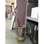 An eastern brass stick stand containing