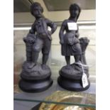 A pair of cast metal figures of children