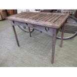 A weathered teak garden table