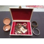 A jewellery box containing an assortment