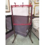 A red painted mesh school coat rack on i