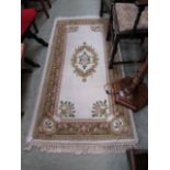 A green and beige patterned rug