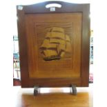 A mid-20th century teak fire screen havi