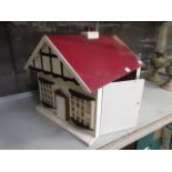 A hand made wooden dolls house containin