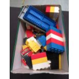 A shoe box of building blocks and Lego