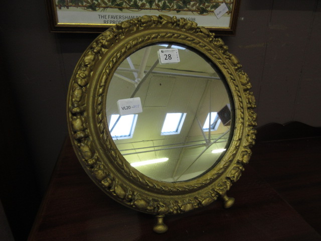 A circular gilt painted easel mirror