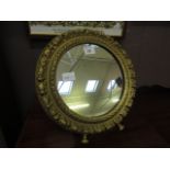 A circular gilt painted easel mirror