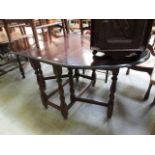 A mid-20th century oak gate leg table