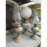 Four brass and ceramic oil lamps one bei