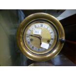 A brass cased bulk head clock