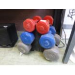 Three sets of dumb bells on rack