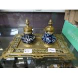 A brass embossed inkstand with two ceram