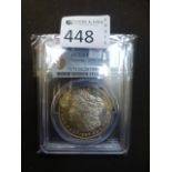 A slabbed 1886 Morgan dollar (cleaned-un