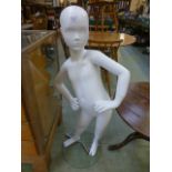 A child mannequin on a stand