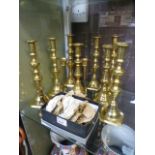 Five pairs of brass candlesticks along w