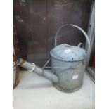 A galvanized watering can