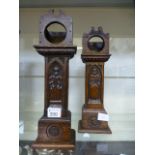 A pair of carved oak watch holders in th