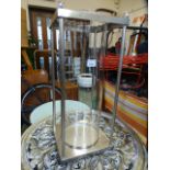 A modern chrome and glass candle holder