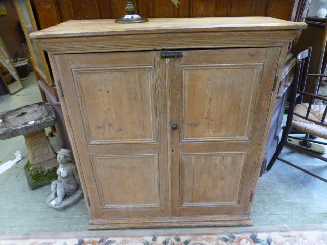 A 19th century pine two door cupboard