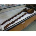 A large eastern carved wooden fork and s