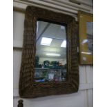 A wicker framed rectangular mirror