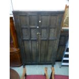 An oak two door wardrobe with carved pan