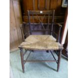 An 18th century oak open armchair with r