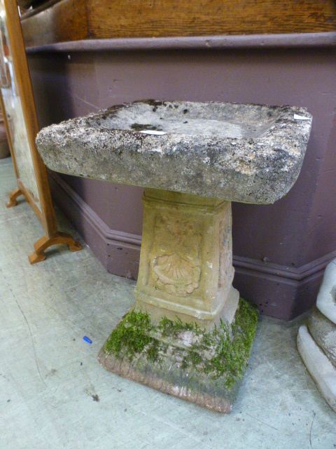 A composite stone bird bath