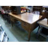 An early 20th century oak desk, the top