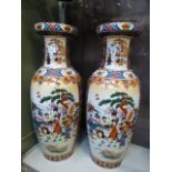 A pair of large Japanese vases depicting