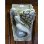A composite stone garden wall hanging or