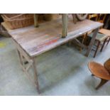 A pine trestle table with folding legs