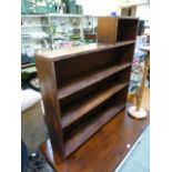 A stained pine multi-level open bookcase