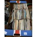 A tray containing 45s by various artists