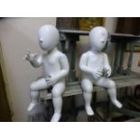 Two white baby mannequins