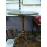 A late Victorian walnut tripod table wit