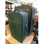 Two green suitcases on wheels