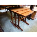 A mid-20th century nest of three tables