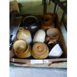 A tray containing stoneware storage pots