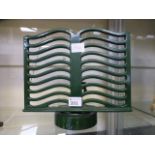 A green metal book holder