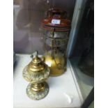 An early 20th century paraffin lamp toge