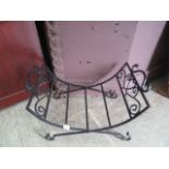 A wrought iron black painted log basket
