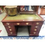 A mahogany twin pedestal desk with a gre