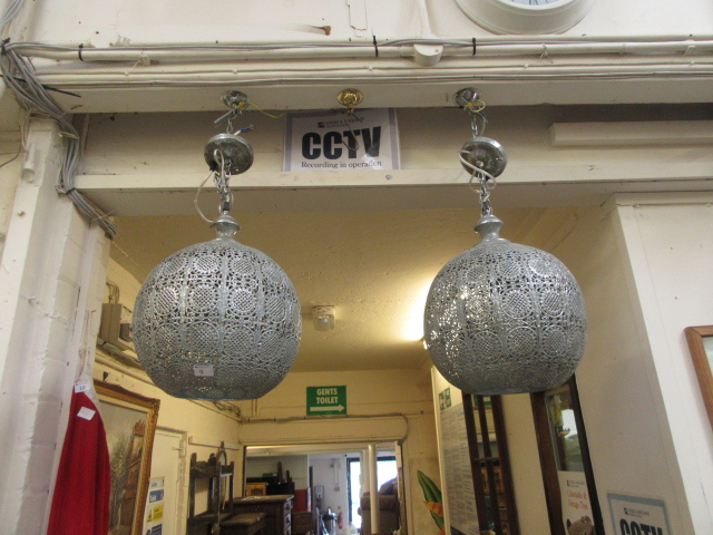 A pair of eastern metalwork light fitmen