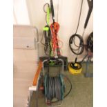 A hose on reel together with a strimmer,