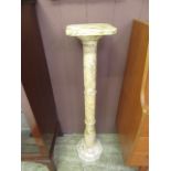 A marble effect jardiniere stand