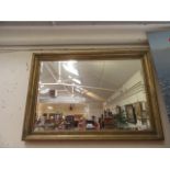 A rectangular gilt painted wall mirror