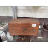 A carved wooden hinged box containing an