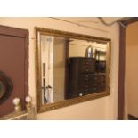 A gilt framed bevel glass wall mirror