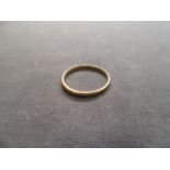 A 22ct gold wedding band. Approx weight